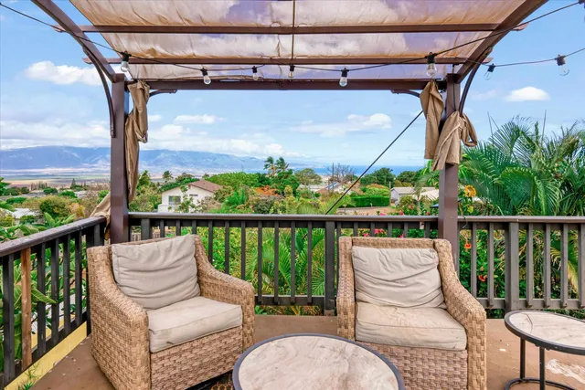 a view of a chair and tables in the balcony