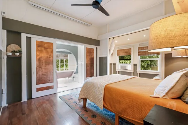 a bedroom with a large bed and a large window