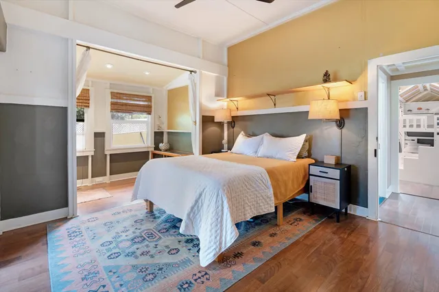 a bedroom with a bed and wooden floor