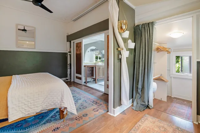 a bedroom with a bed and a mirror