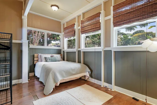 a bedroom with a large bed and a large window