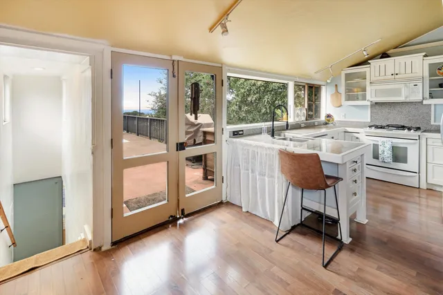 a kitchen with a table chairs refrigerator and cabinets