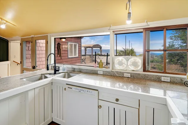 a kitchen with a sink cabinets and window