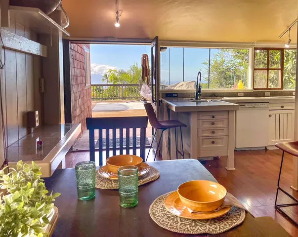 a dining room with furniture a rug and a chandelier