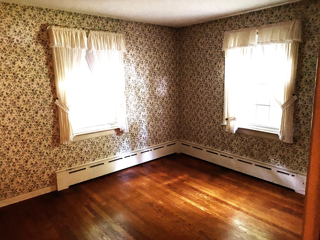 463 Bailey Road, Unit 1 Holden, MA 01520 - Photo 11 of 18 a view of an empty room with a window and wooden floor