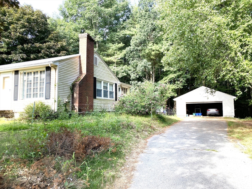 463 Bailey Road, Unit 1 Holden, MA 01520 - Photo 2 of 18 a view of a house with a yard and potted plants