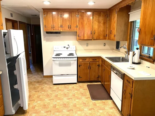a kitchen with a sink stove and refrigerator