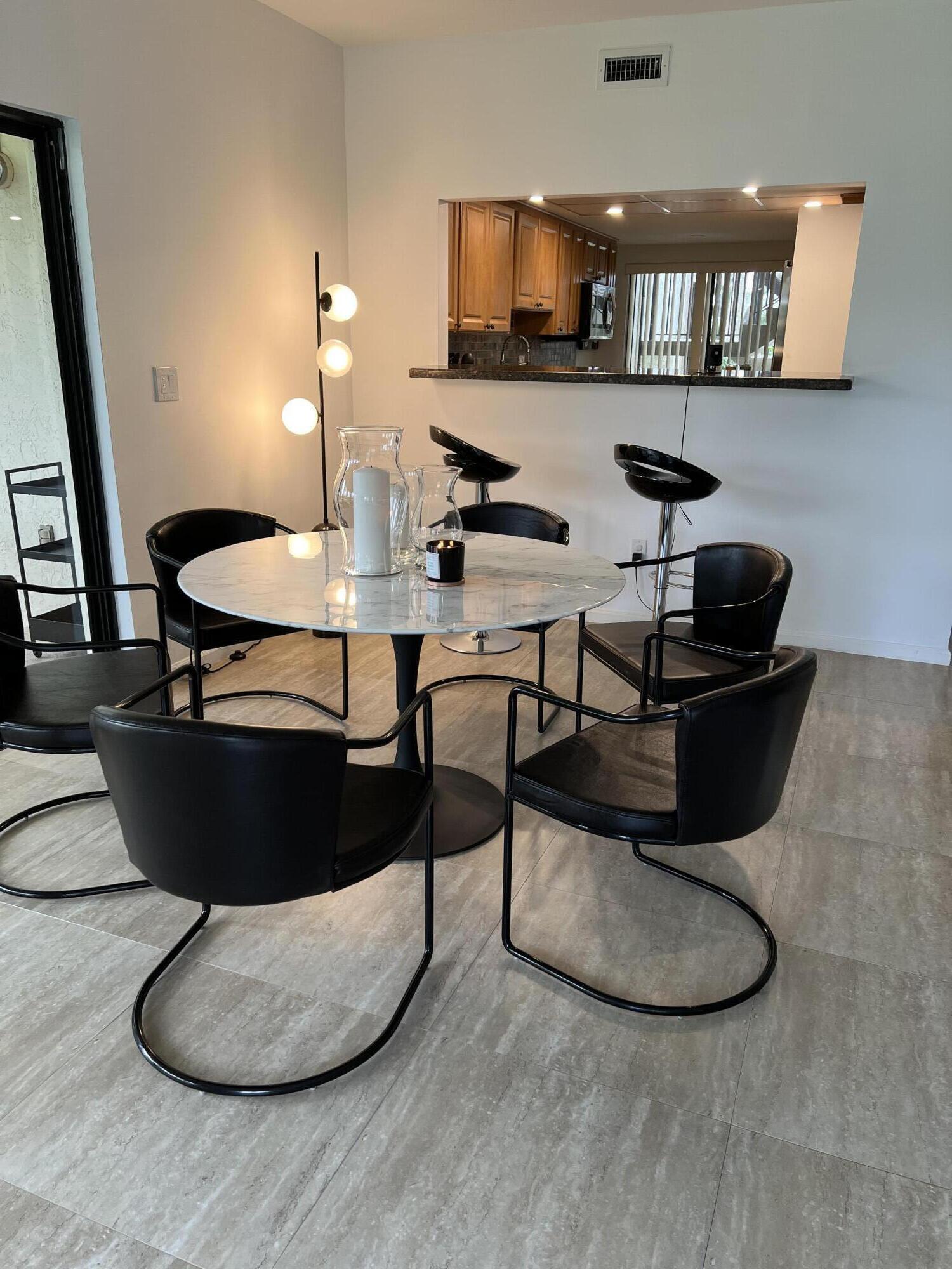 13400 Polo Road West Wellington, FL 33414 - Photo 2 of 16 a living room with table and chairs