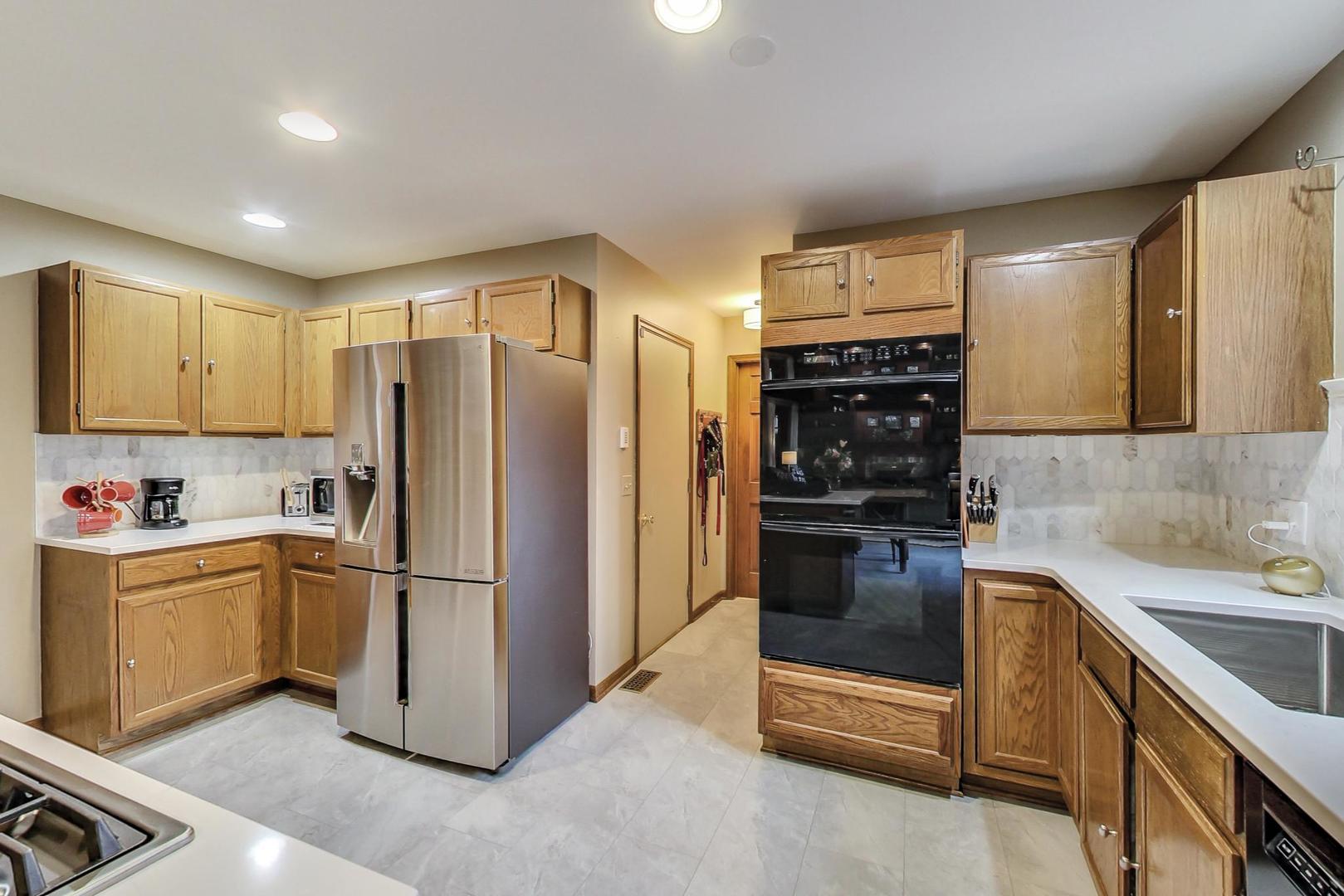 2185 Maplewood Drive Gurnee, IL 60031 - Photo 12 of 65 a kitchen with stainless steel appliances granite countertop a refrigerator and a stove top oven