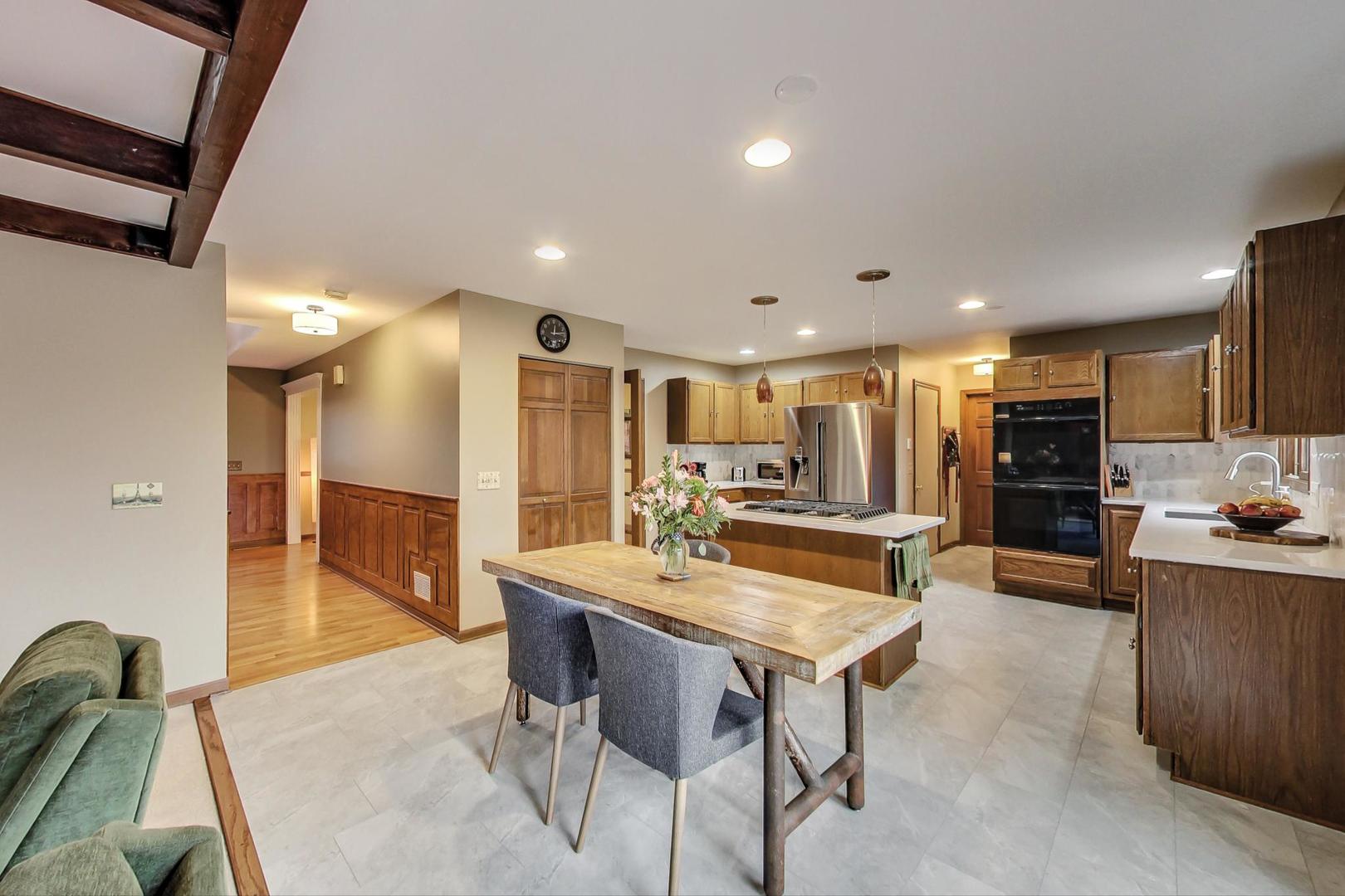 2185 Maplewood Drive Gurnee, IL 60031 - Photo 16 of 65 a kitchen with a table and chairs in it