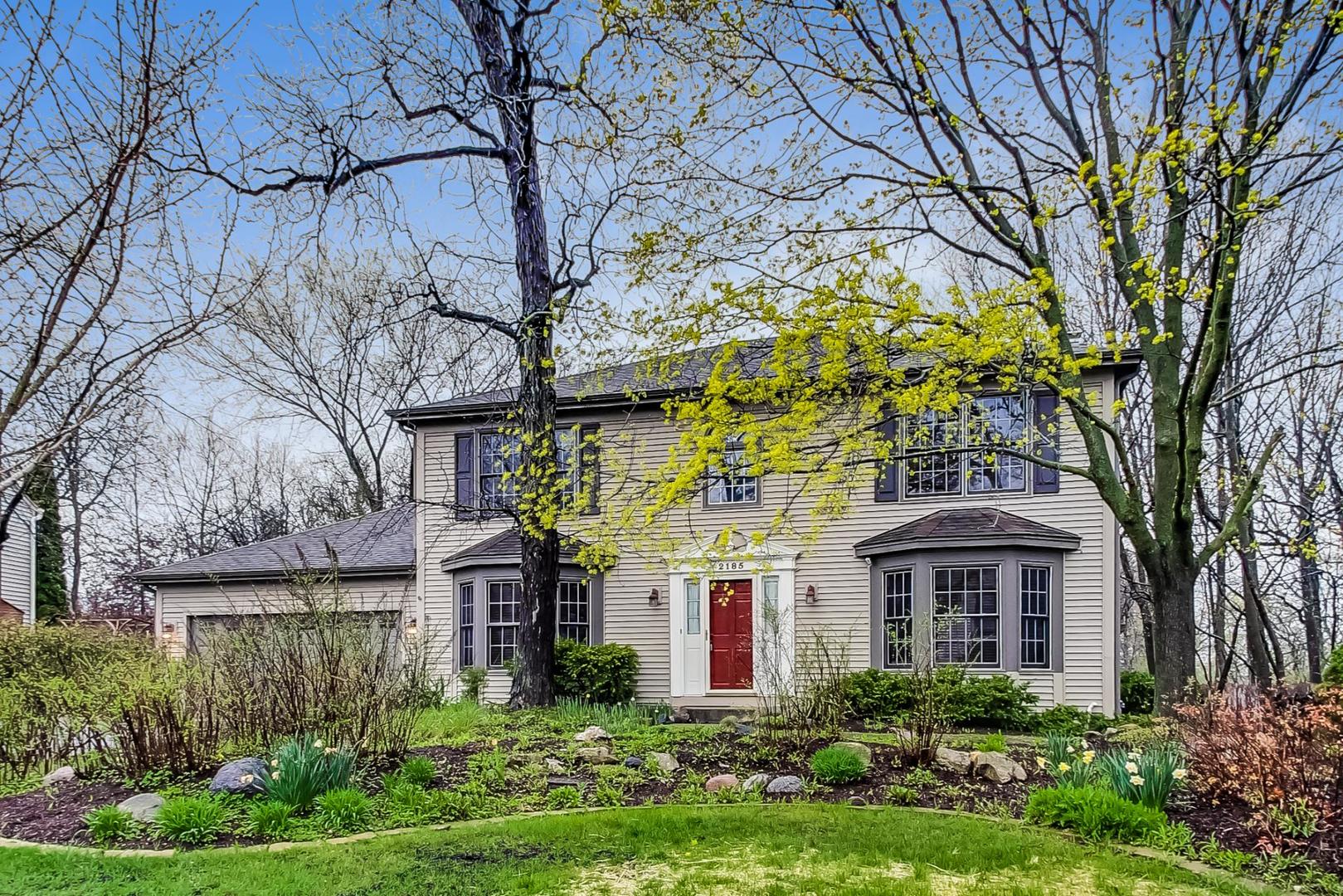 2185 Maplewood Drive Gurnee, IL 60031 - Photo 2 of 65 a front view of a house with garden