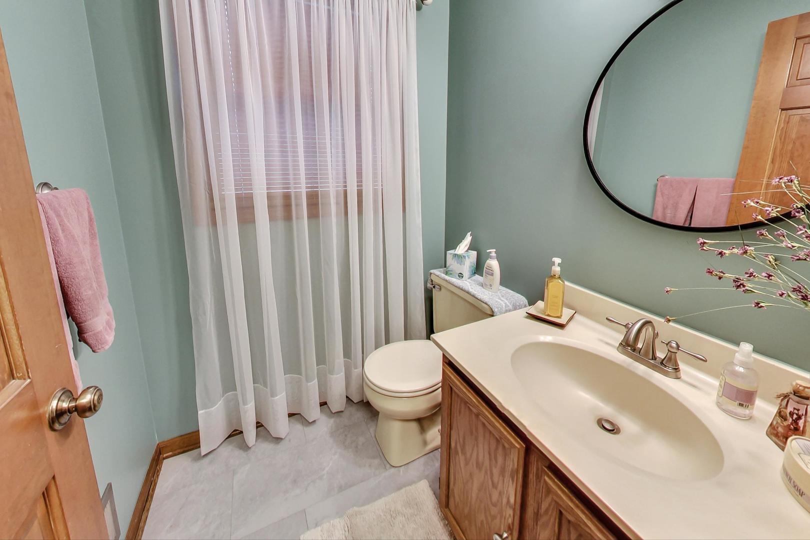2185 Maplewood Drive Gurnee, IL 60031 - Photo 21 of 65 a bathroom with a sink and a mirror