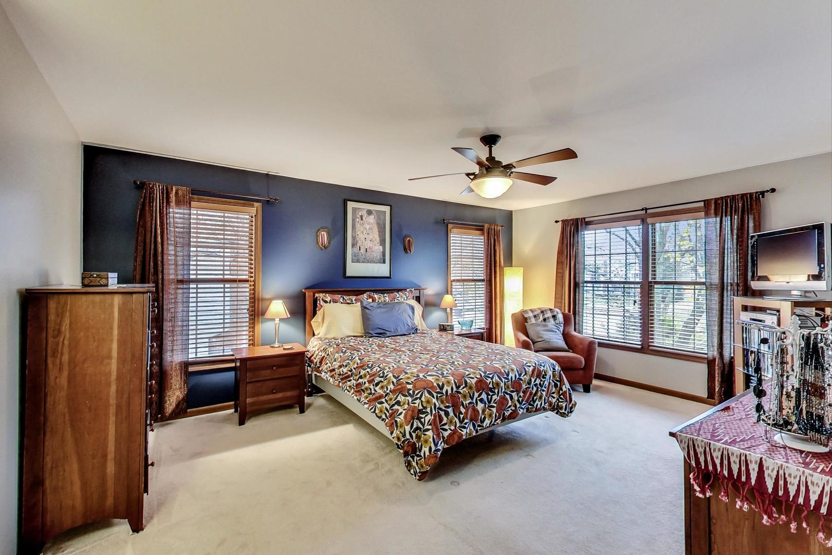 2185 Maplewood Drive Gurnee, IL 60031 - Photo 23 of 65 a bedroom with a bed and a dresser with mirror