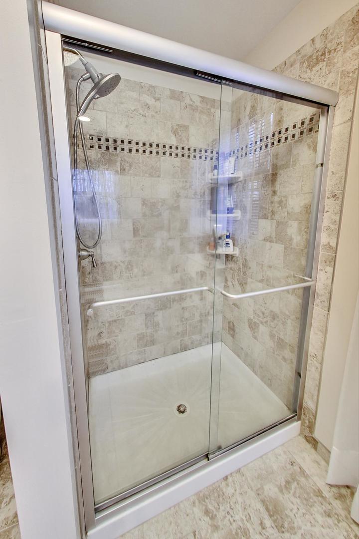 2185 Maplewood Drive Gurnee, IL 60031 - Photo 29 of 65 a bathroom with a glass shower door