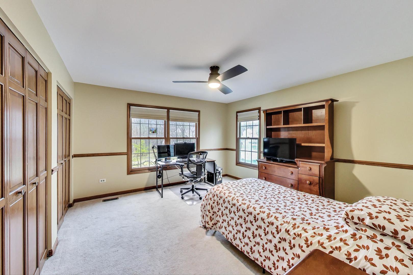 2185 Maplewood Drive Gurnee, IL 60031 - Photo 30 of 65 a bedroom with furniture and a flat screen tv