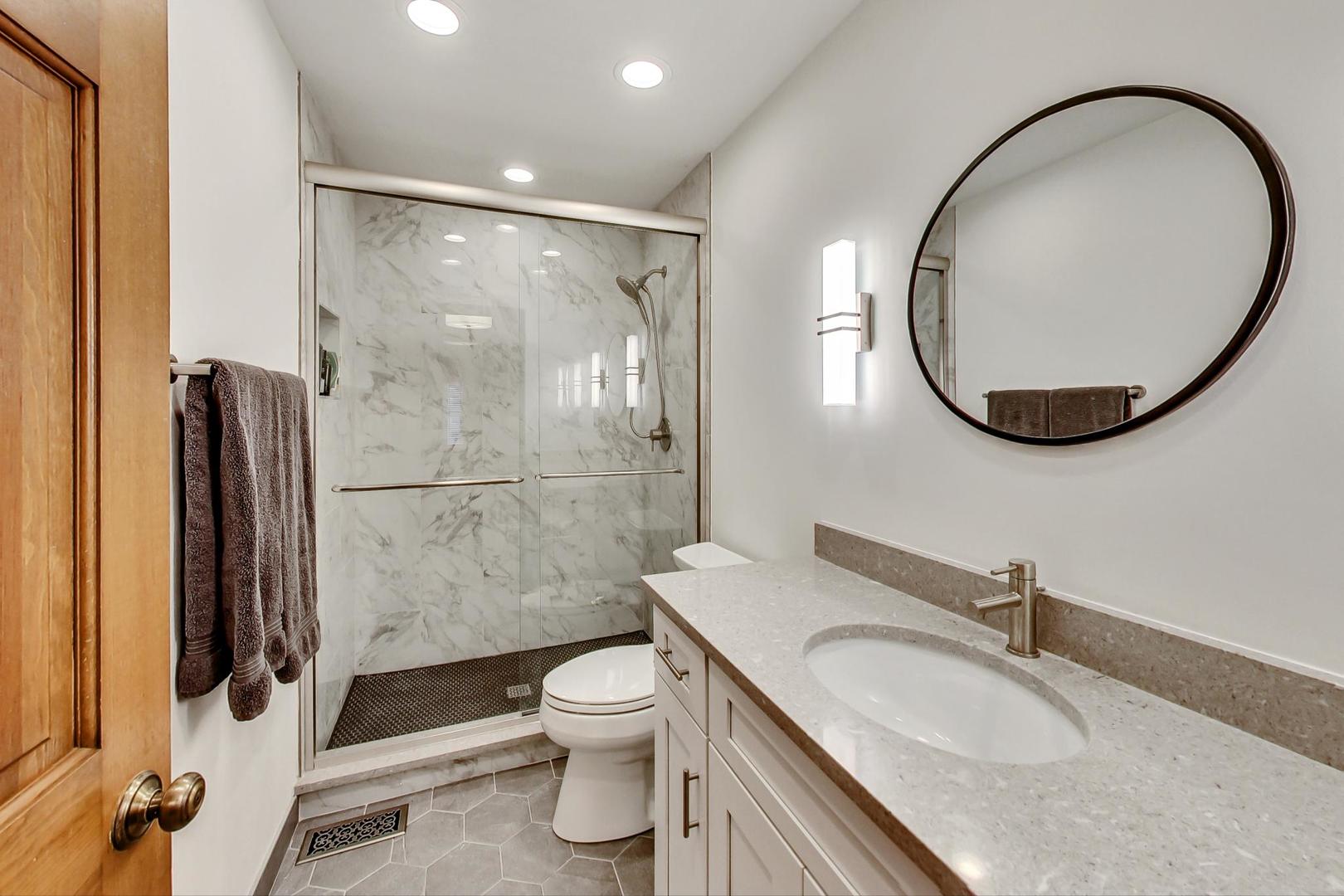 2185 Maplewood Drive Gurnee, IL 60031 - Photo 38 of 65 a bathroom with a sink a toilet and a mirror