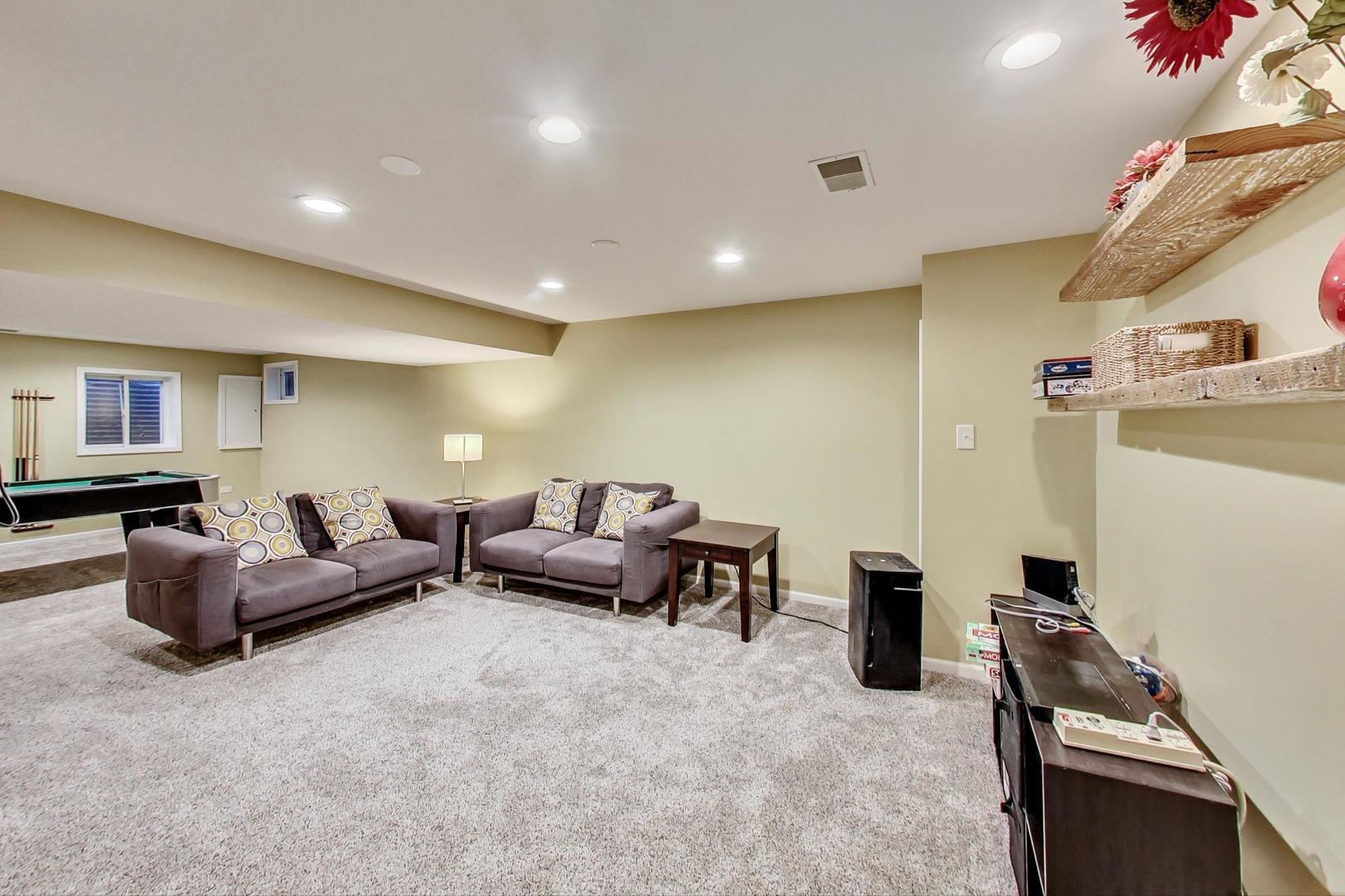 2185 Maplewood Drive Gurnee, IL 60031 - Photo 39 of 65 a living room with furniture and a flat screen tv