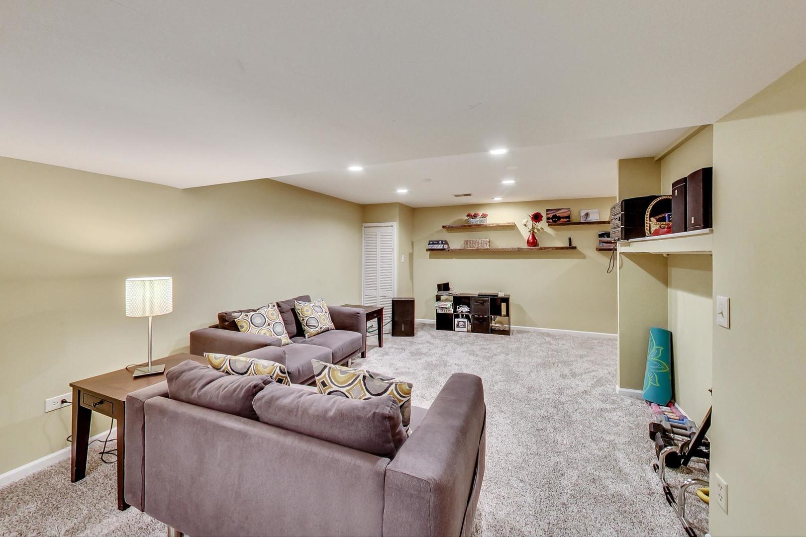 2185 Maplewood Drive Gurnee, IL 60031 - Photo 41 of 65 a living room with furniture and a flat screen tv