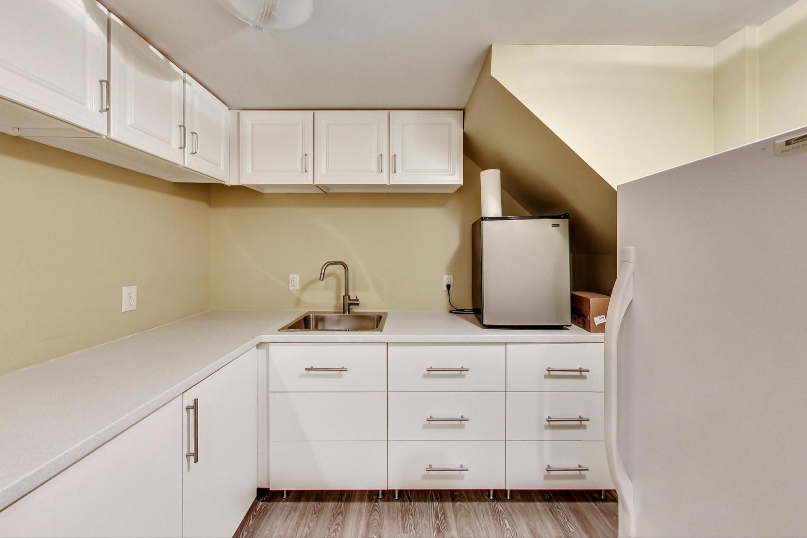 2185 Maplewood Drive Gurnee, IL 60031 - Photo 46 of 65 a kitchen with white cabinets and sink