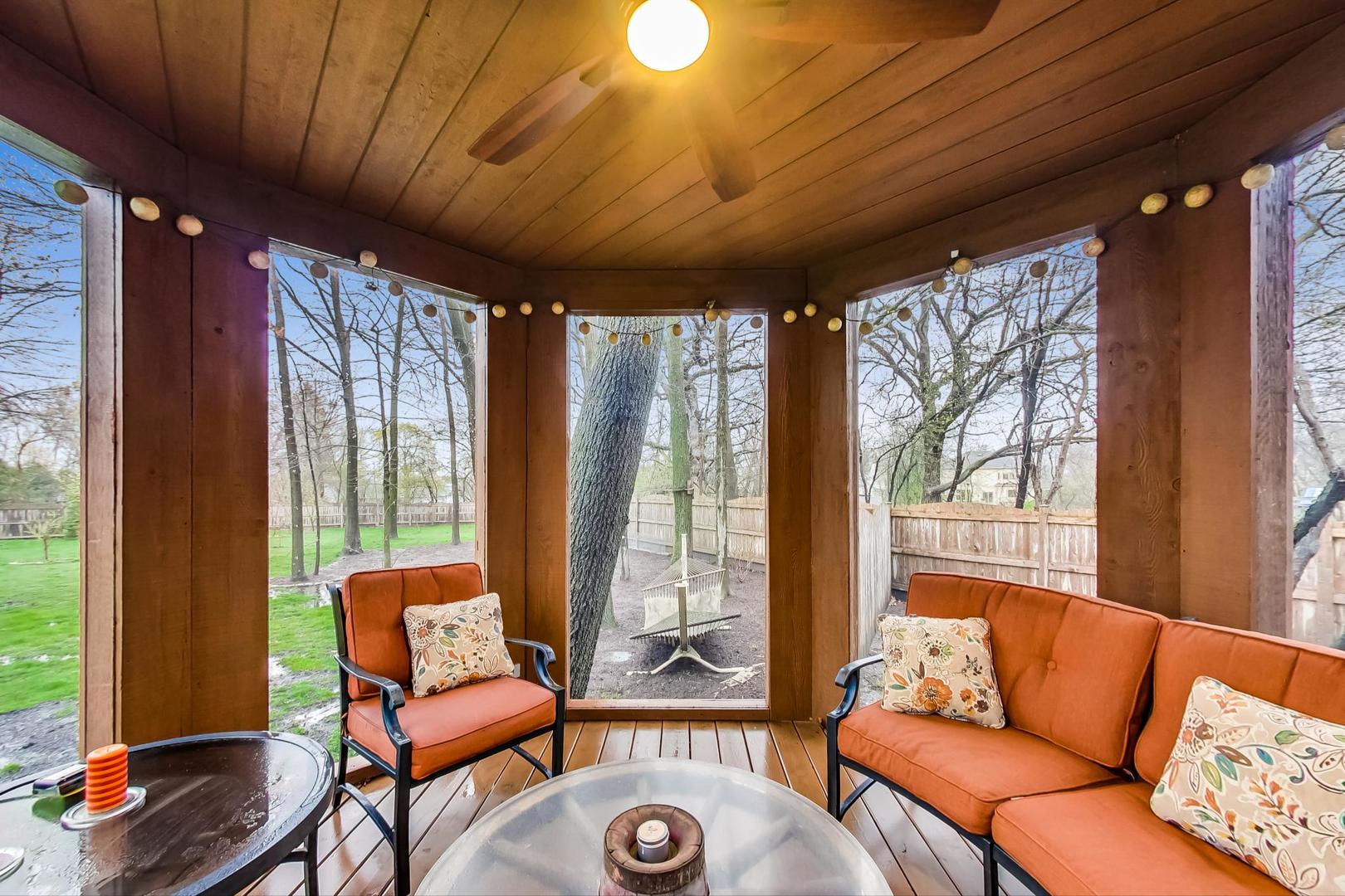 2185 Maplewood Drive Gurnee, IL 60031 - Photo 51 of 65 a living room with furniture a ceiling fan and a large window