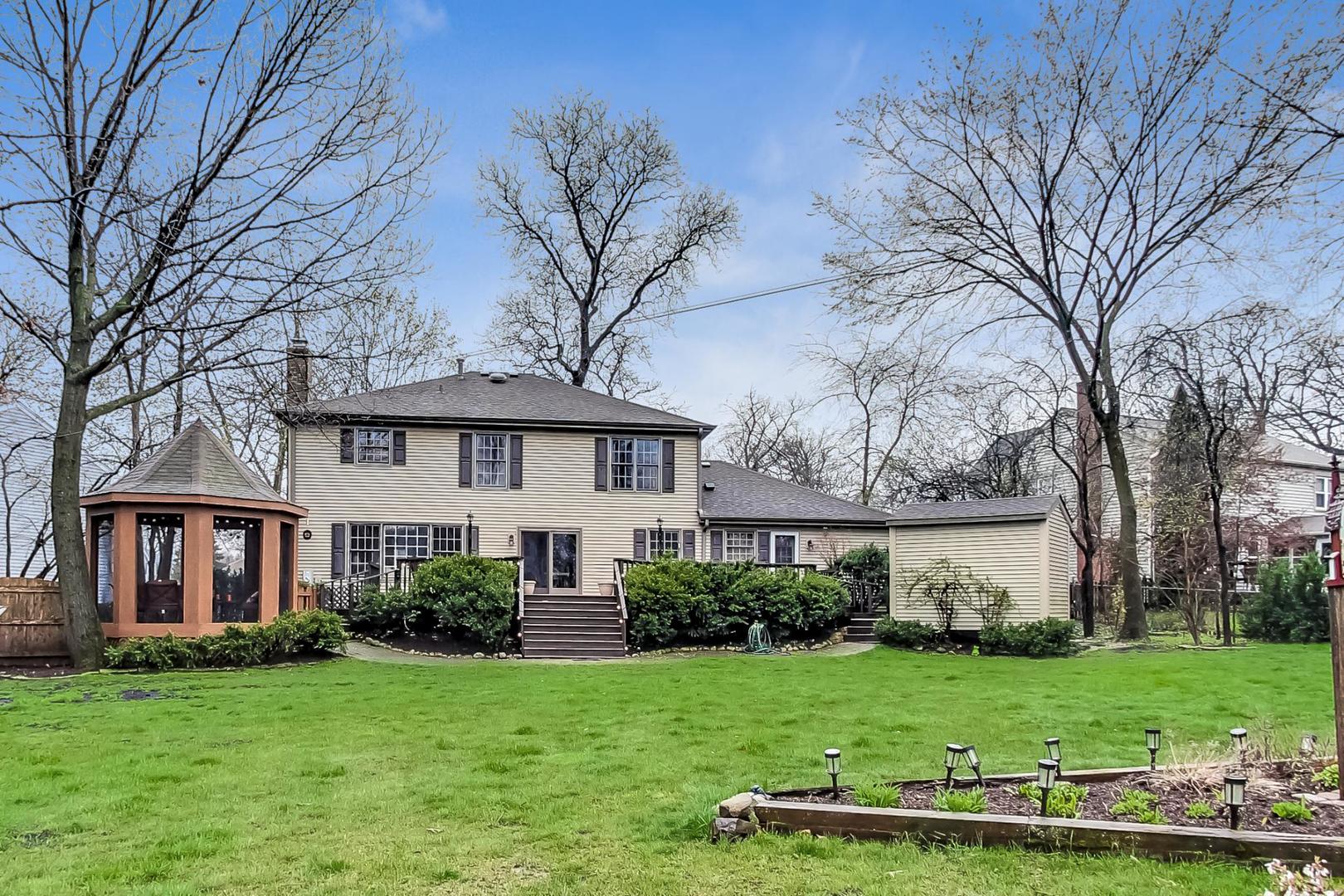 2185 Maplewood Drive Gurnee, IL 60031 - Photo 52 of 65 a front view of a house with a yard and trees