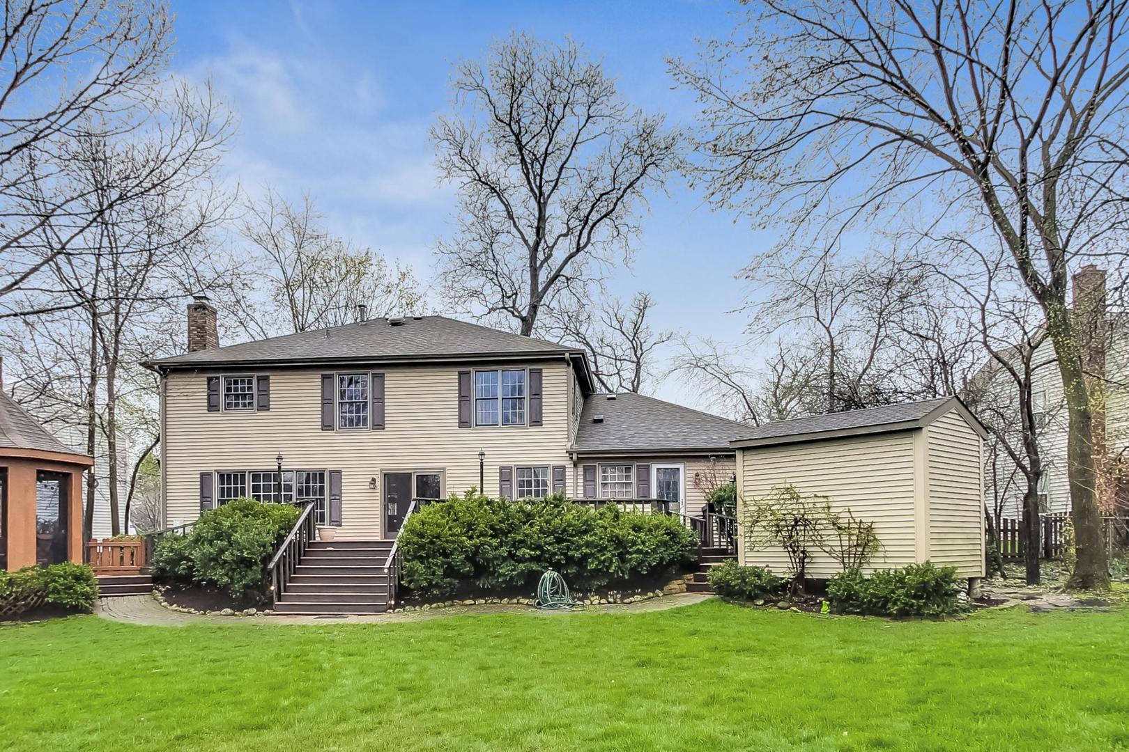 2185 Maplewood Drive Gurnee, IL 60031 - Photo 53 of 65 a front view of a house with a garden