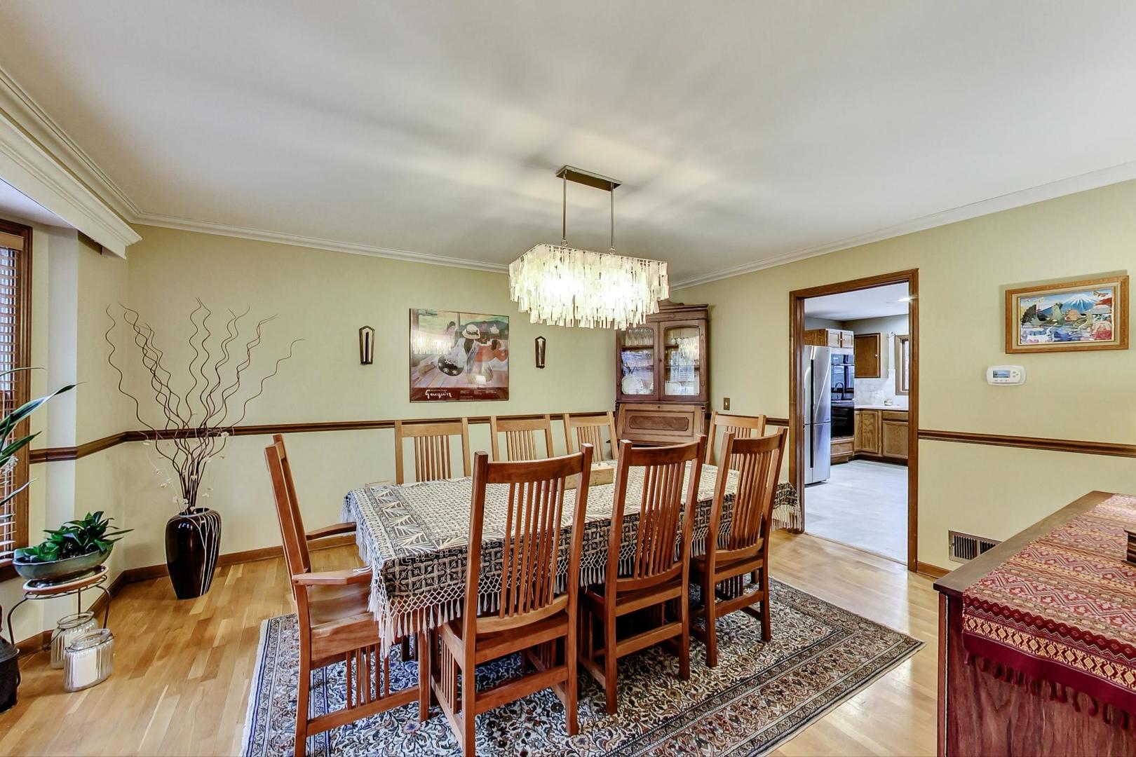 2185 Maplewood Drive Gurnee, IL 60031 - Photo 8 of 65 a view of a dining room with furniture wooden floor and chandelier