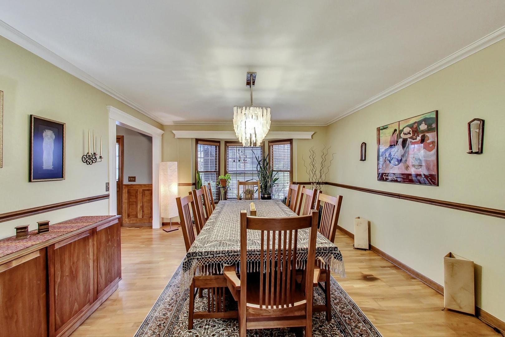 2185 Maplewood Drive Gurnee, IL 60031 - Photo 10 of 65 a dining room with furniture a chandelier and wooden floor