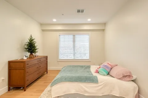 a spacious bedroom with a bed and a window