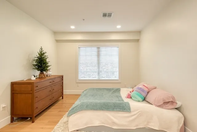 a spacious bedroom with a bed and a window