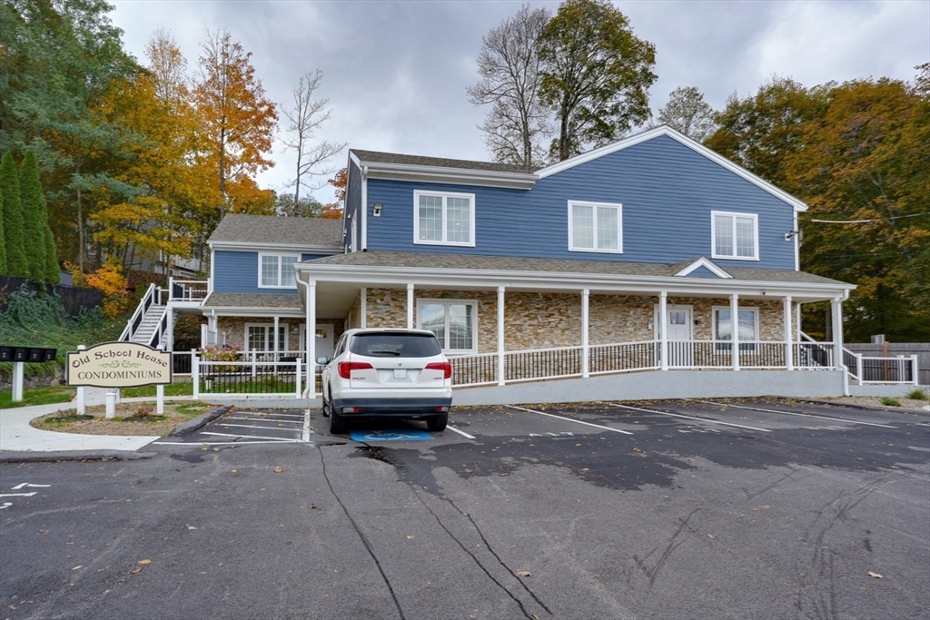17 School Street, Unit C Hudson, MA 01749 - Photo 19 of 21 a front view of a residential apartment building with a yard