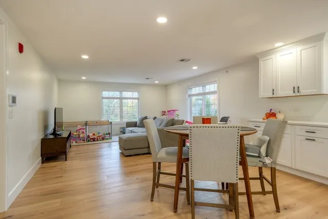 a dining room with furniture and wooden floor