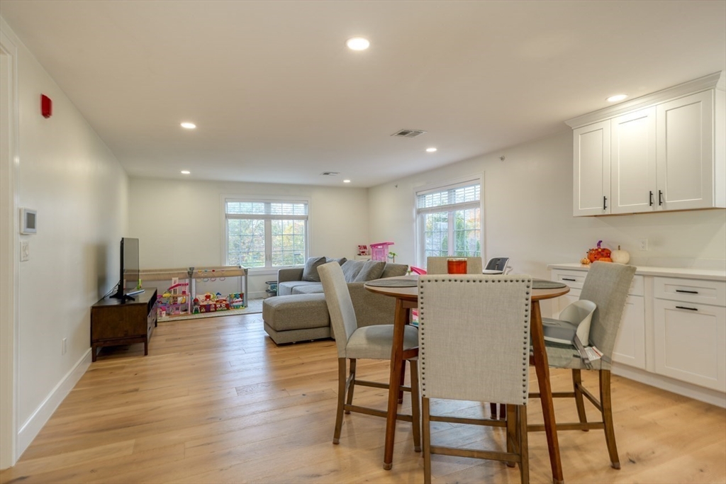 17 School Street, Unit C Hudson, MA 01749 - Photo 7 of 21 a dining room with furniture and wooden floor