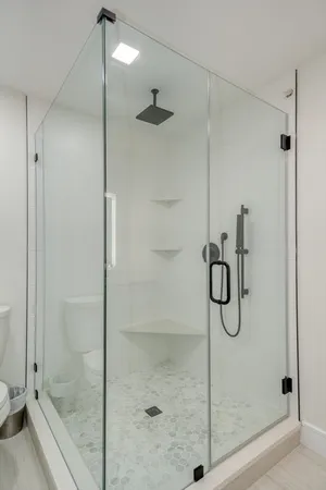 a bathroom with a glass shower door