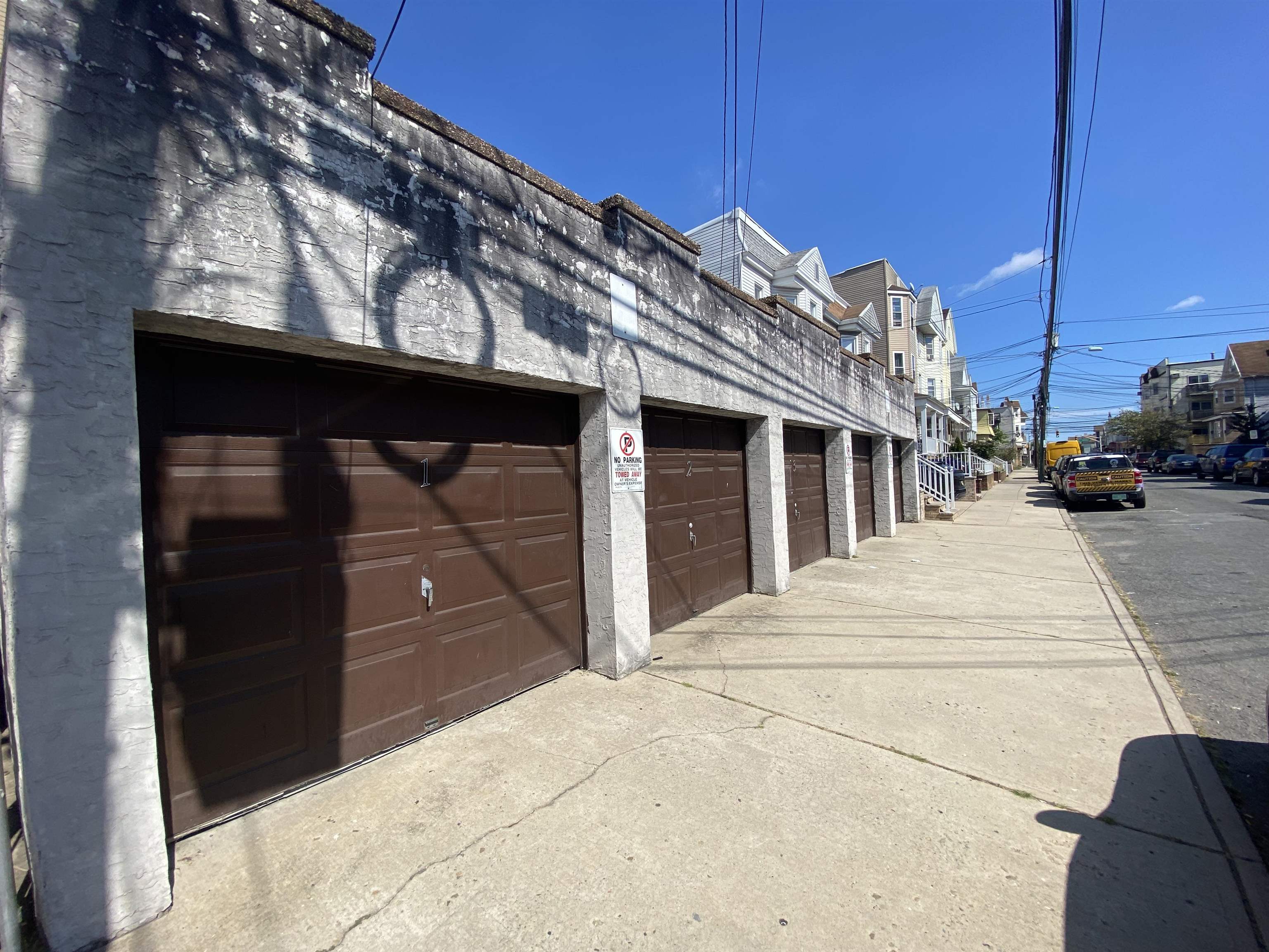 a view of a house with a barbeque and wooden stairs