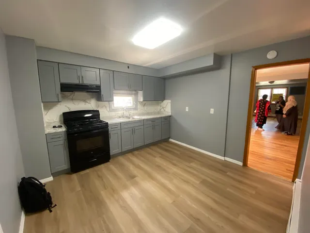 a kitchen with a sink and a stove top oven