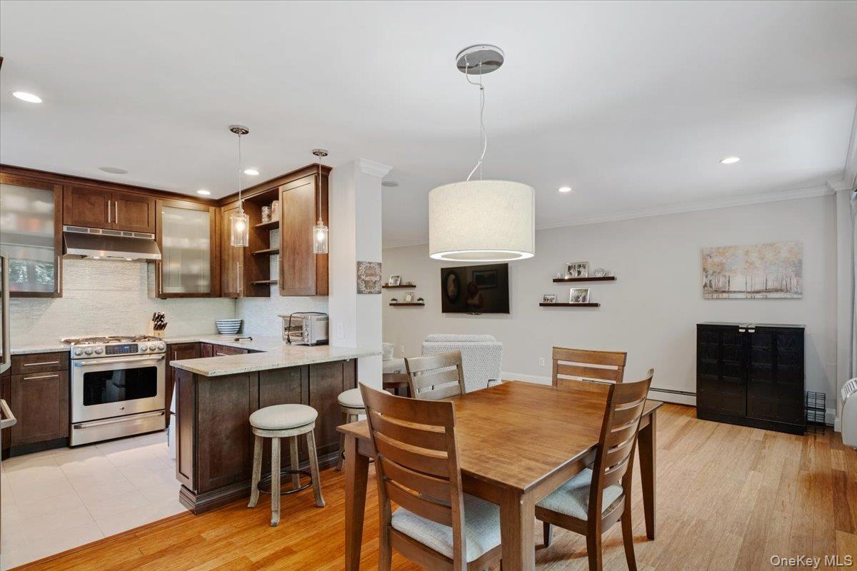 2 Old Mamaroneck Road, Unit 3J White Plains, NY 10605 - Photo 1 of 1 Dining space with light wood finished floors, recessed lighting, a baseboard radiator, and crown molding