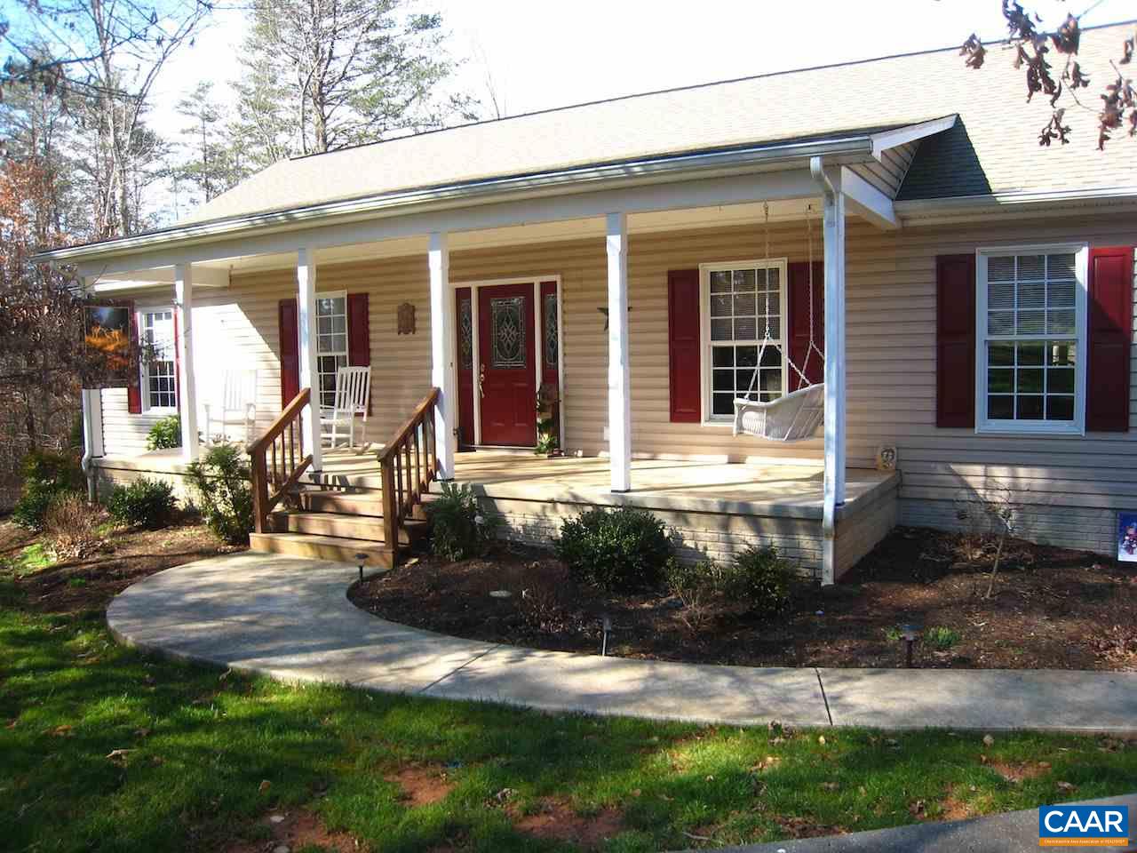 a front view of a house with yard and green space