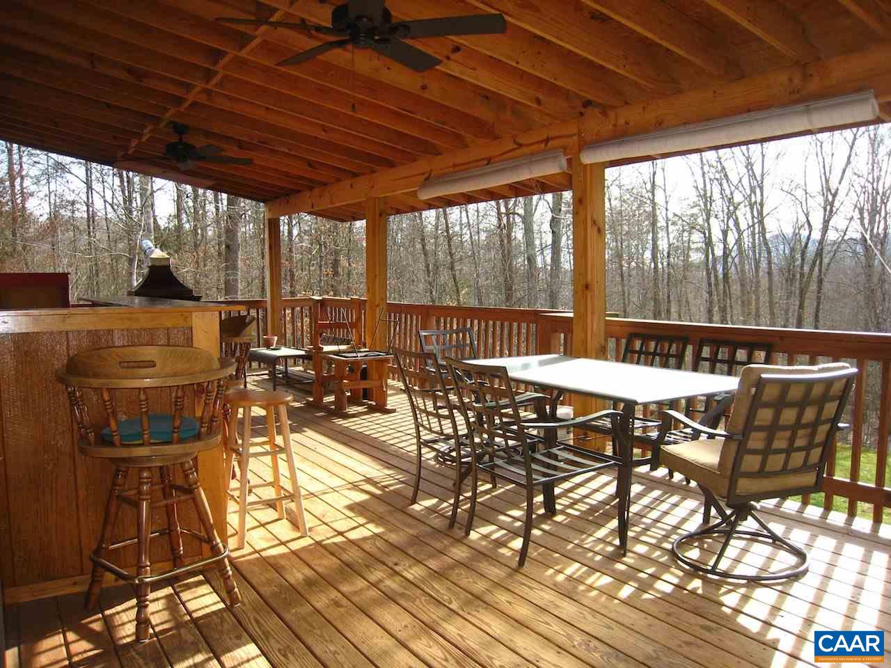 262 Pine Ridge Road Faber, VA 22938 - Photo 17 of 45 a view of a patio with table and chairs and floor to ceiling window with wooden floor