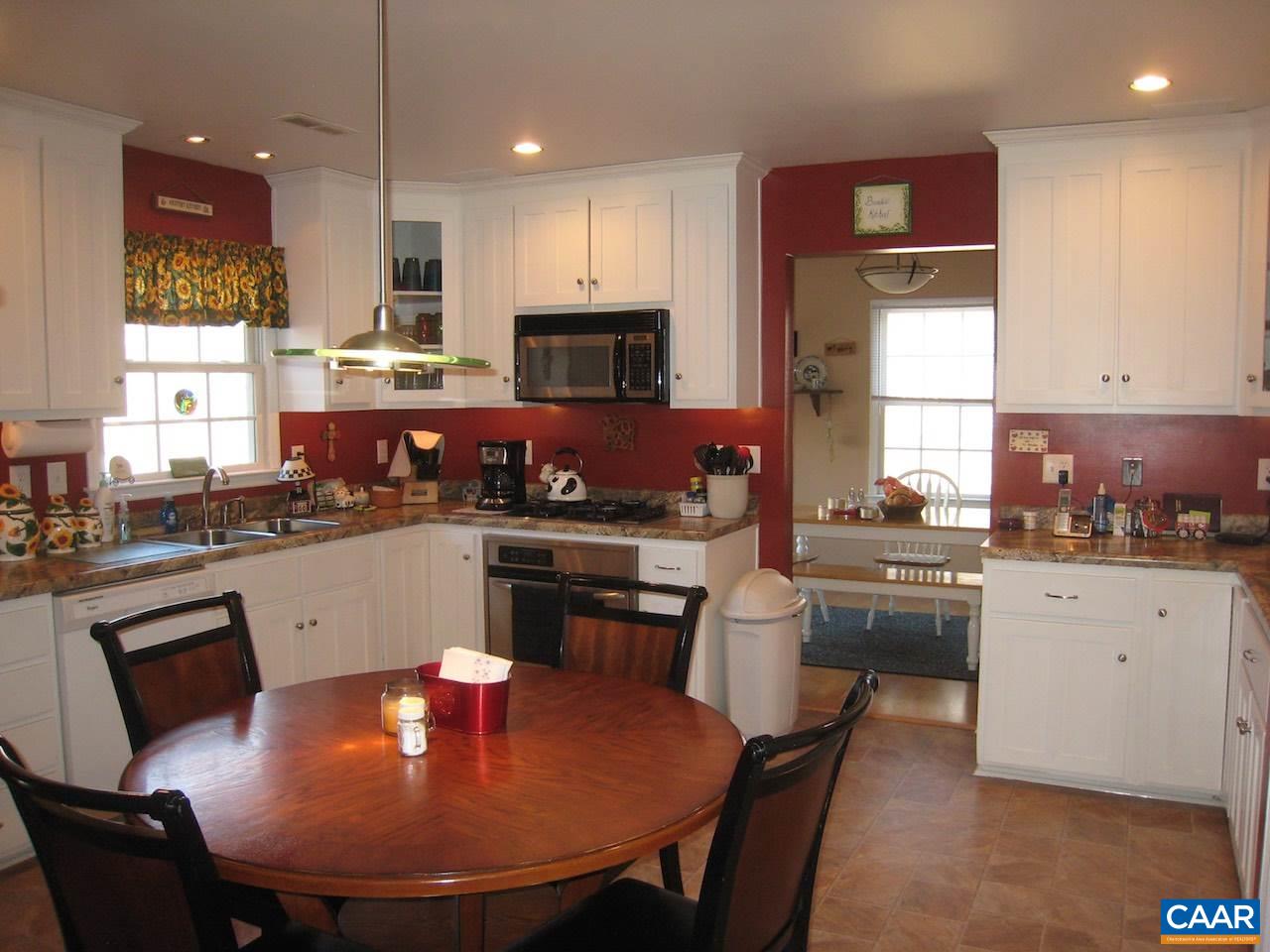 262 Pine Ridge Road Faber, VA 22938 - Photo 23 of 45 a kitchen with stainless steel appliances granite countertop a stove a sink a microwave a dining table and chairs