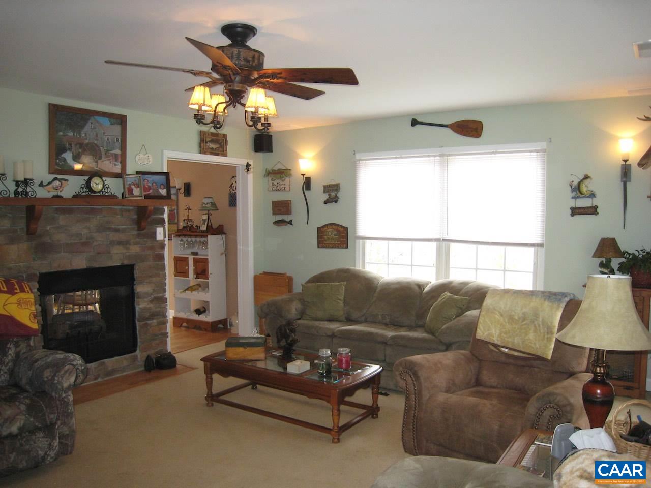 262 Pine Ridge Road Faber, VA 22938 - Photo 29 of 45 a living room with furniture a chandelier and a fireplace