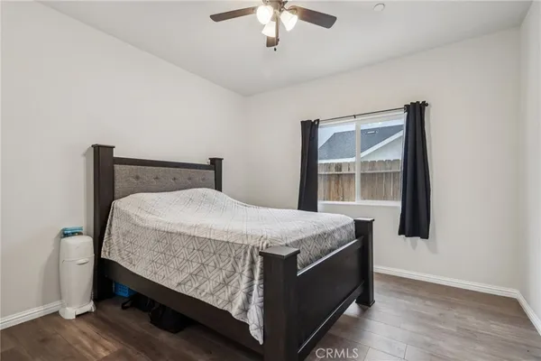 a bed sitting in a bedroom next to a window
