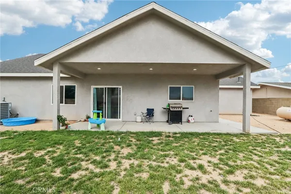 a front view of house with yard and seating space