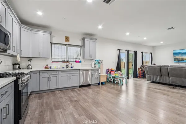 a kitchen that has a lot of cabinets a sink and appliances in it