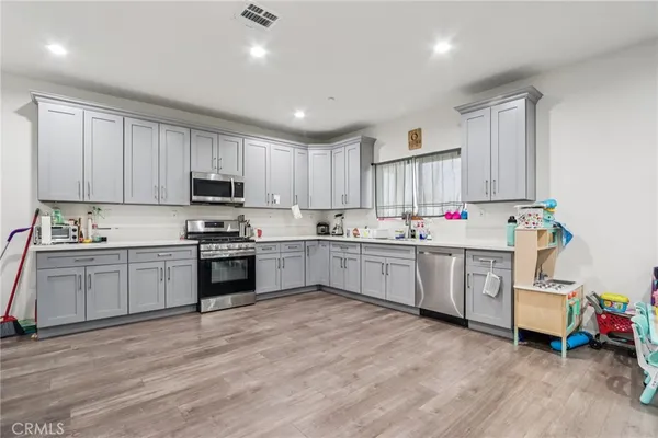a kitchen with granite countertop white cabinets and white appliances