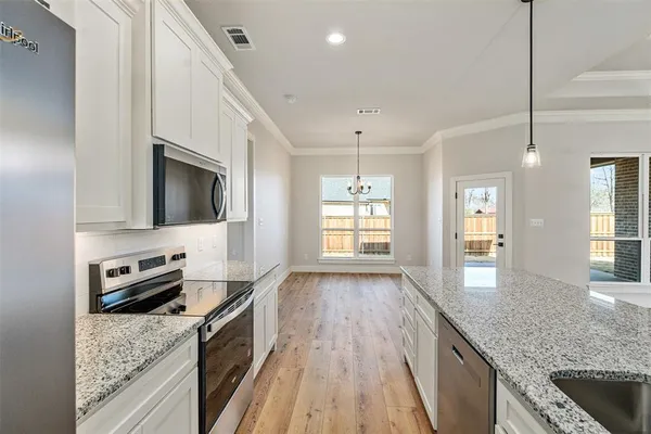 a kitchen with granite countertop a stove oven and sink