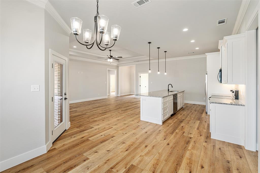 502 Limestone Circle Mabank, TX 75147 - Photo 13 of 38 a view of a kitchen with wooden floor and stainless steel appliances