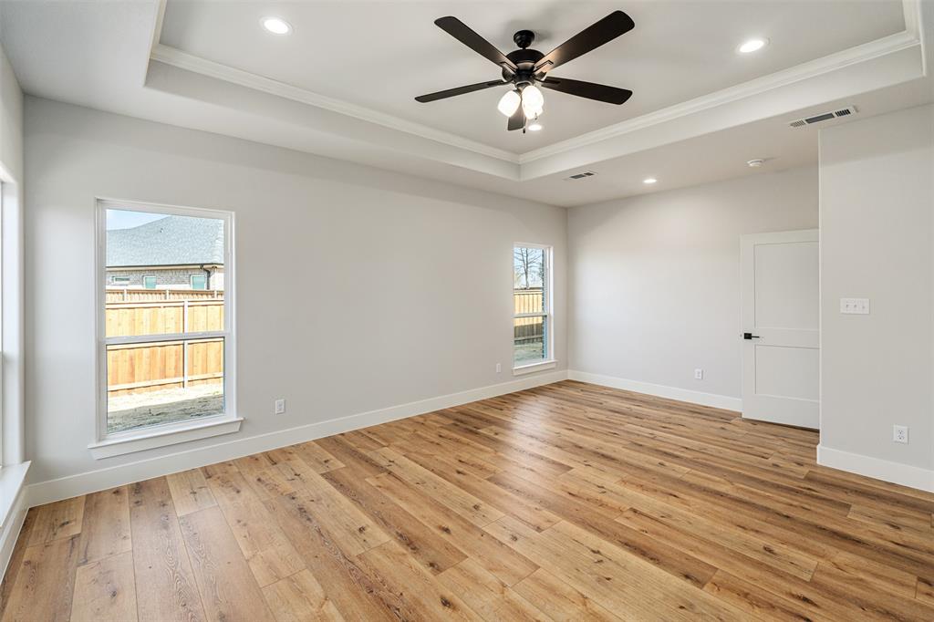 502 Limestone Circle Mabank, TX 75147 - Photo 15 of 38 an empty room with wooden floor and windows