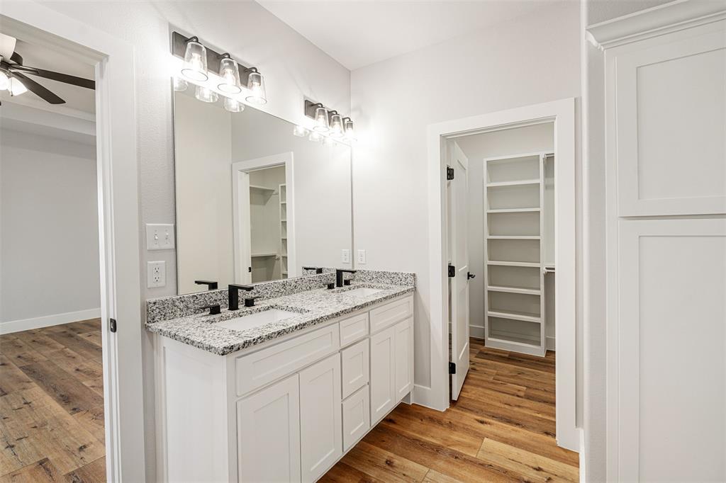 502 Limestone Circle Mabank, TX 75147 - Photo 16 of 38 a bathroom with a granite countertop sink and a mirror