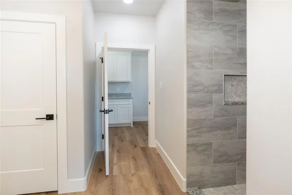 a bathroom with a shower and a glass door